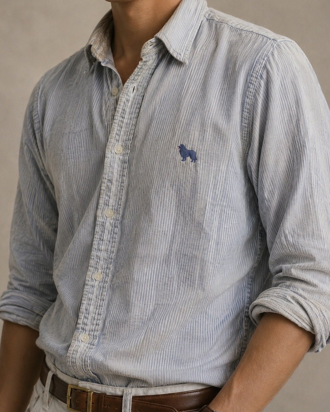 The Inherited Oxford worn with the sleeves rolled, faded blue stripe with Harper on the chest